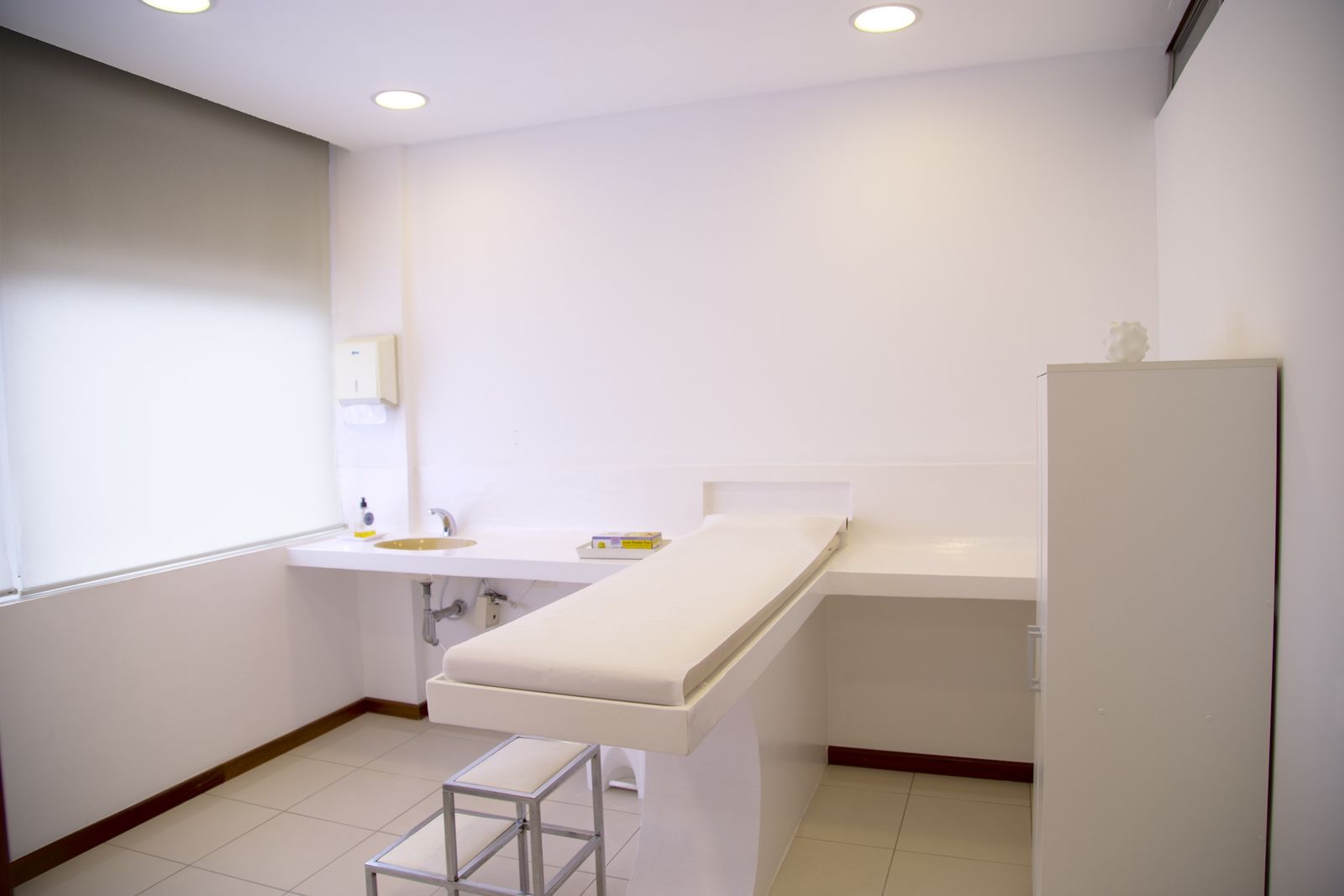 Bright aesthetic clinic treatment room where a laser or IPL machine is used